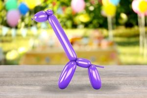 Giraffe balloon sculpting in purple