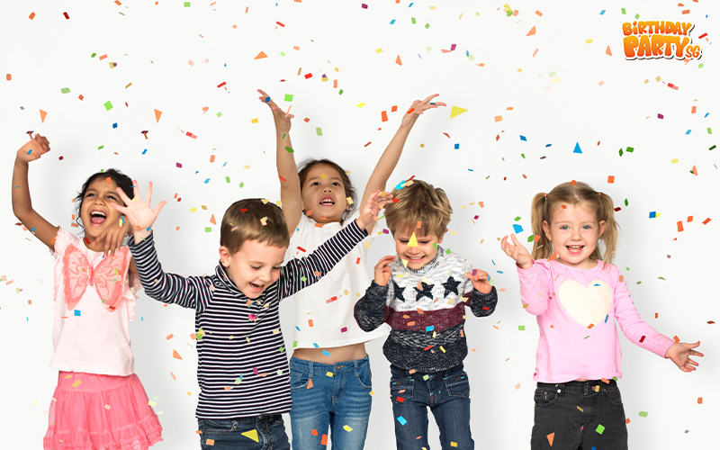 Happy children celebrating with confetti at a birthday party