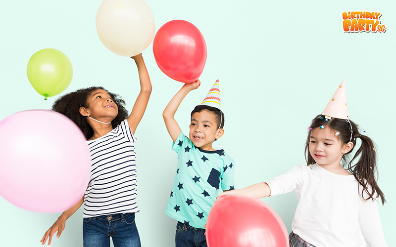 Kids playing with balloons at a birthday party